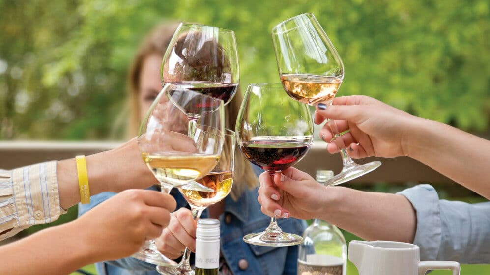 Glasses of wine bing clinked together