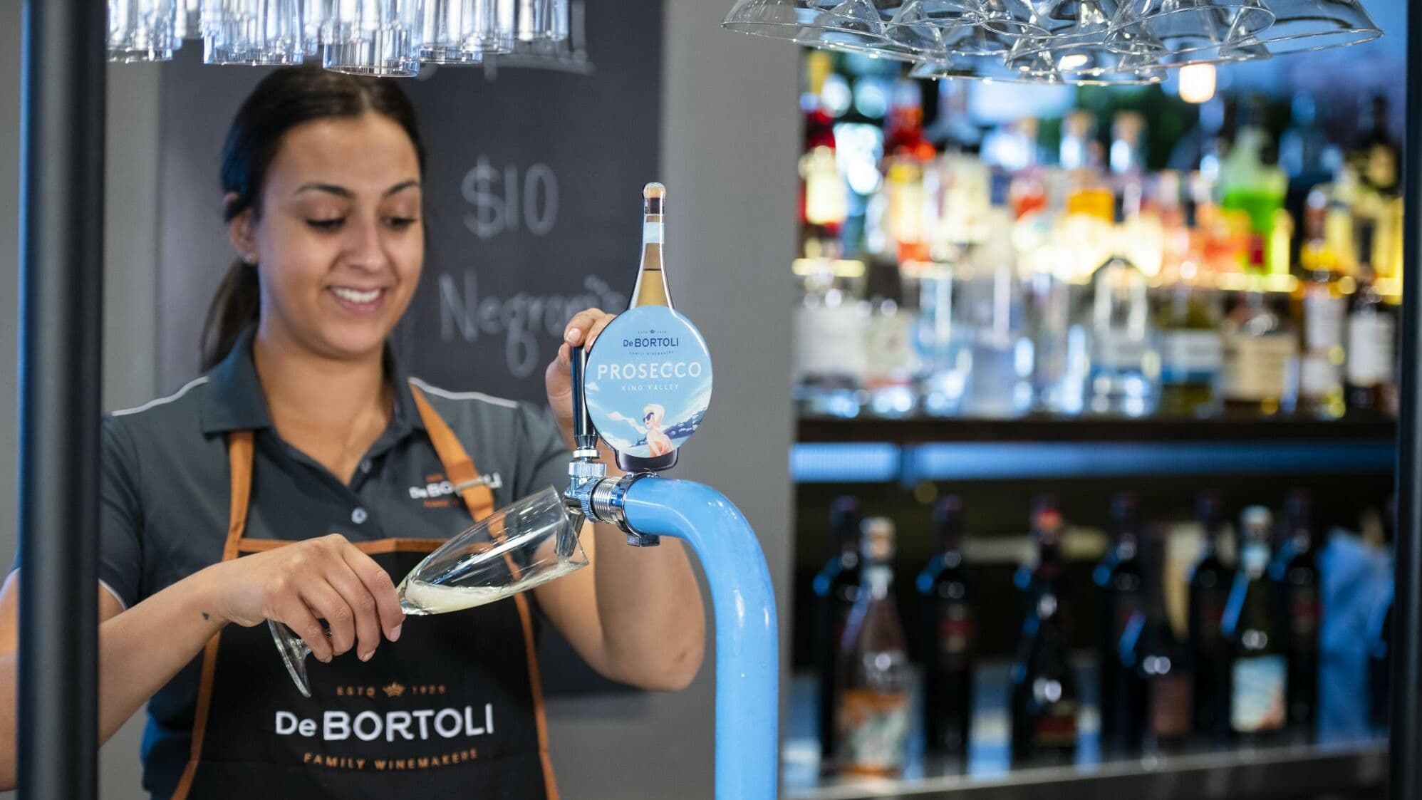 Bartender pouring De Bortoli Prosecco from Wine By The Glass system