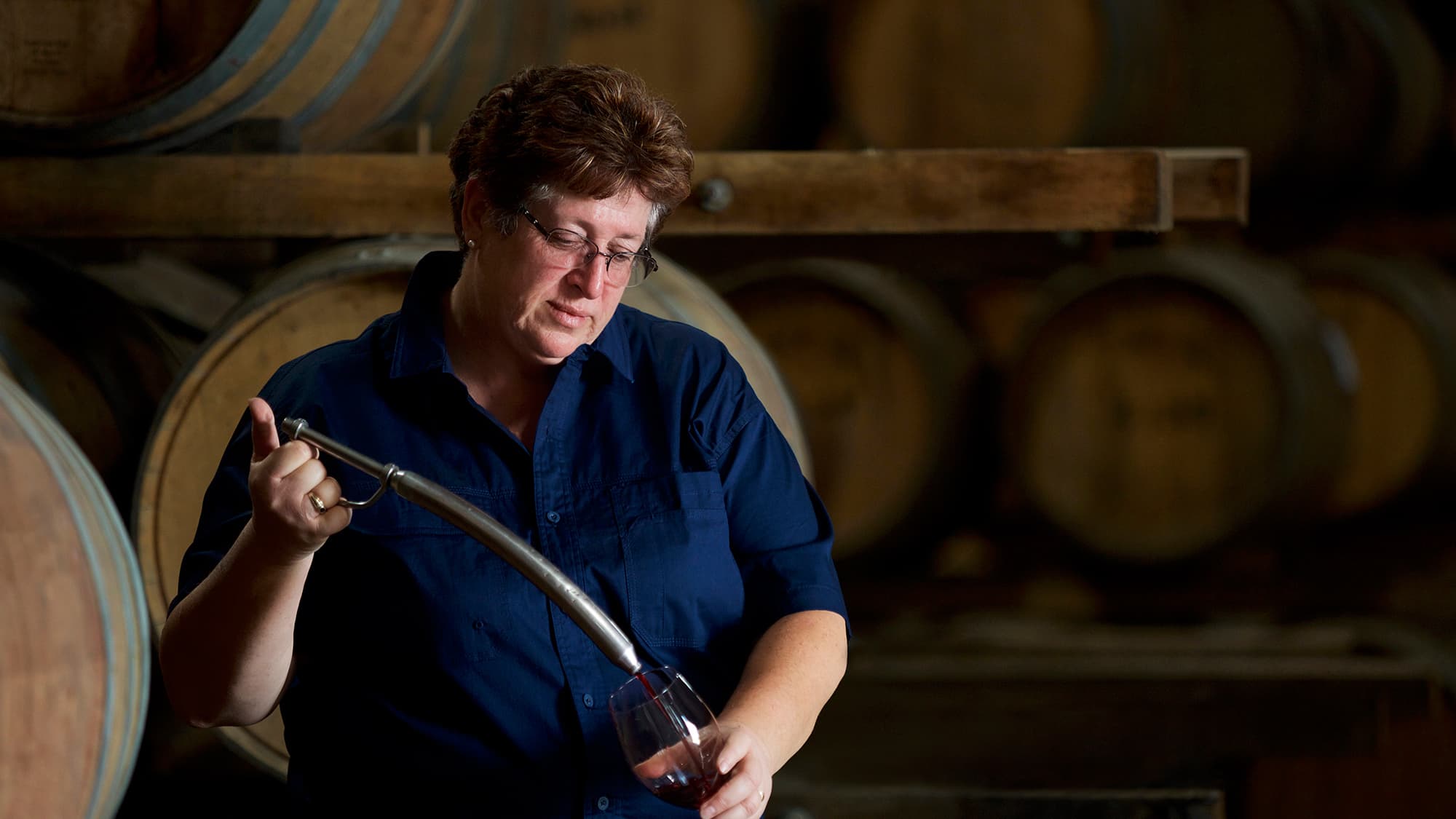 Julie Mortlock, De Bortoli Winemaker at Bilbul winery, Riverina, checking fortified wine barrel samples