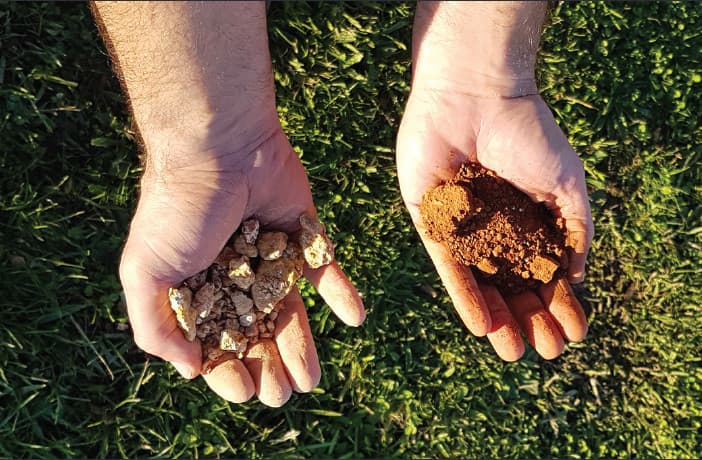 Two hands showing soil
